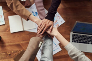 Photo of work colleagues putting their hands together
