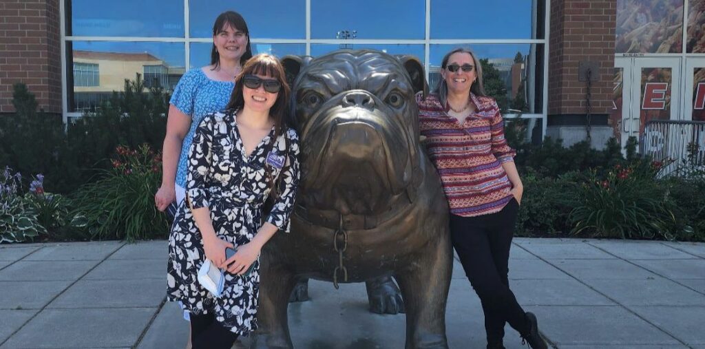 Lesley Lowery, Lori Hilterbrand, and Tamara Marnell with the Gonzaga bulldog statue