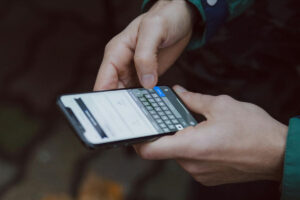 Photo of hands using the keyboard on a smartphone